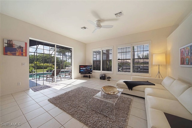 tiled living room featuring ceiling fan