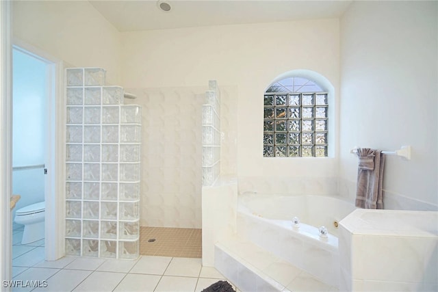 bathroom with toilet, tile patterned flooring, and shower with separate bathtub