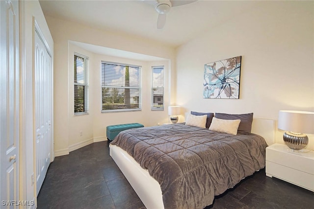 bedroom with ceiling fan and a closet