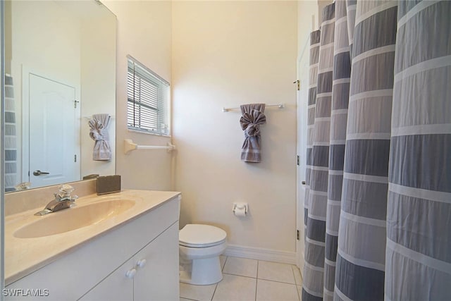 bathroom featuring toilet, vanity, and tile patterned floors