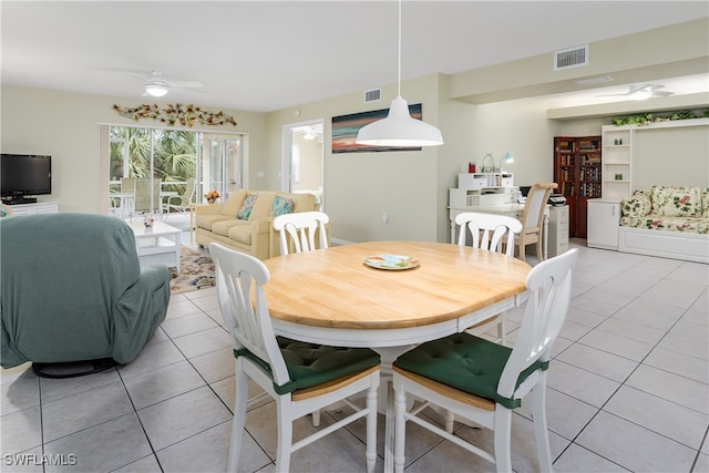 tiled dining area with ceiling fan