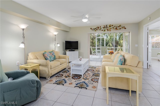 tiled living room featuring ceiling fan and a wealth of natural light