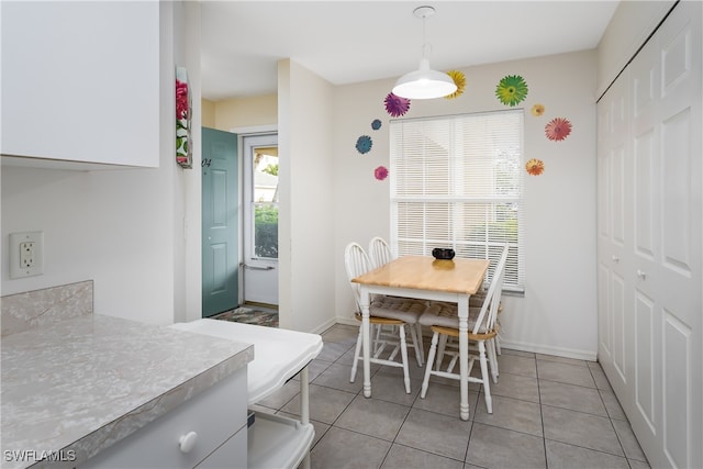 dining area featuring light tile patterned floors and a healthy amount of sunlight