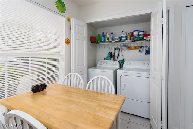 laundry room with washing machine and dryer and light tile patterned floors