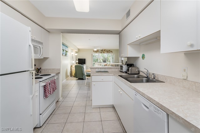 kitchen featuring white cabinets, white appliances, sink, and light tile patterned floors