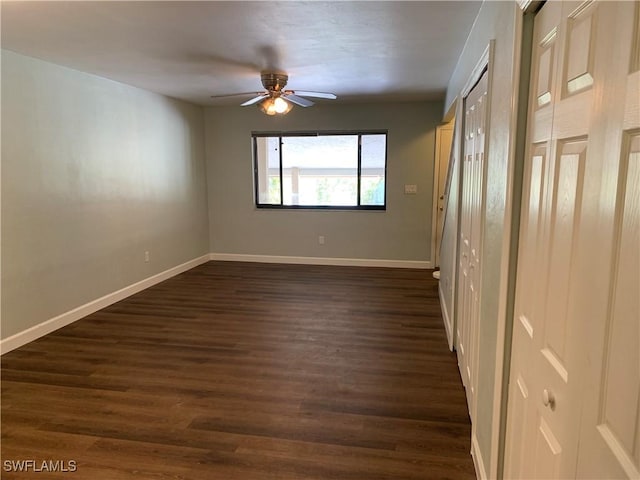 unfurnished bedroom featuring ceiling fan and dark hardwood / wood-style floors