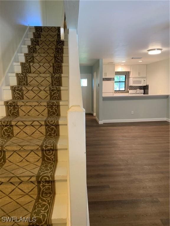 staircase with wood-type flooring