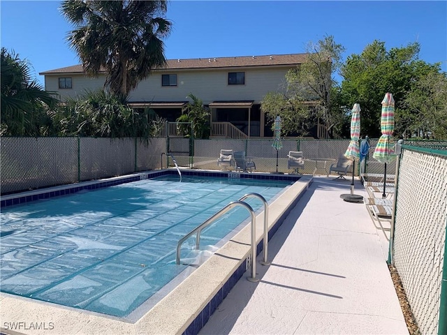 view of swimming pool with a patio