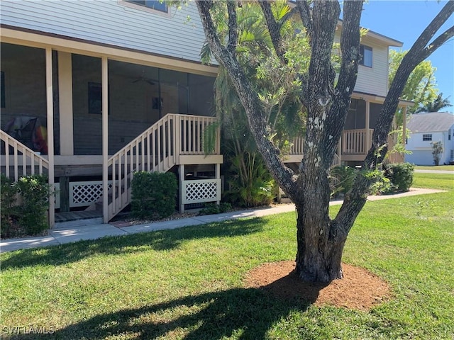 13508 Siesta Pines Ct Unit 8, Fort Myers, FL 33908 - view of green lawn with stairway, a sunroom, and ceiling fan