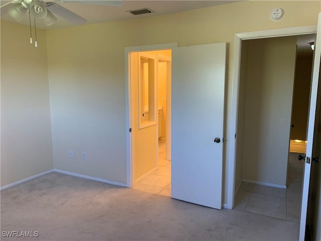 unfurnished bedroom with light colored carpet and ceiling fan