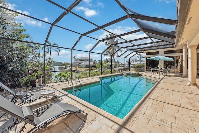 view of swimming pool featuring a lanai, a pool with connected hot tub, and a patio