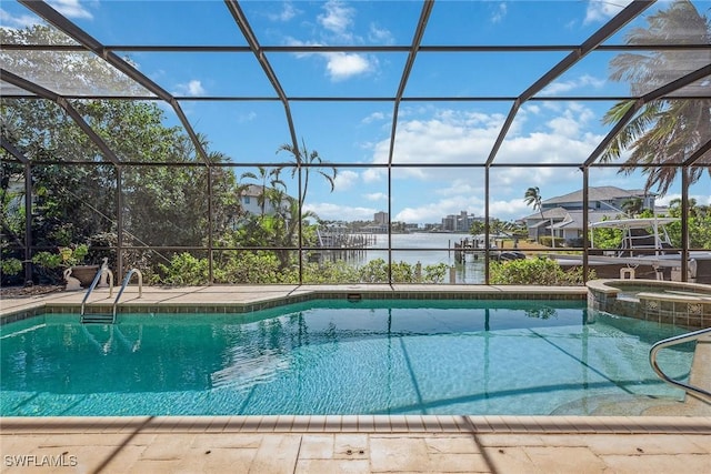 view of pool featuring a water view, glass enclosure, a pool with connected hot tub, and a patio area