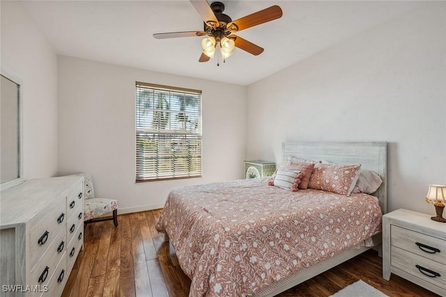 bedroom with baseboards, dark wood finished floors, and a ceiling fan