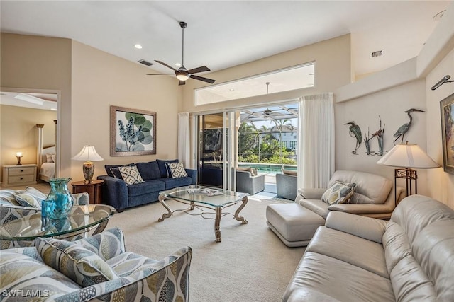 living area with carpet floors, a sunroom, visible vents, and a ceiling fan