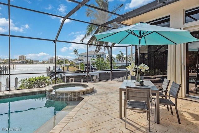 view of patio / terrace with outdoor dining space, a lanai, and a pool with connected hot tub