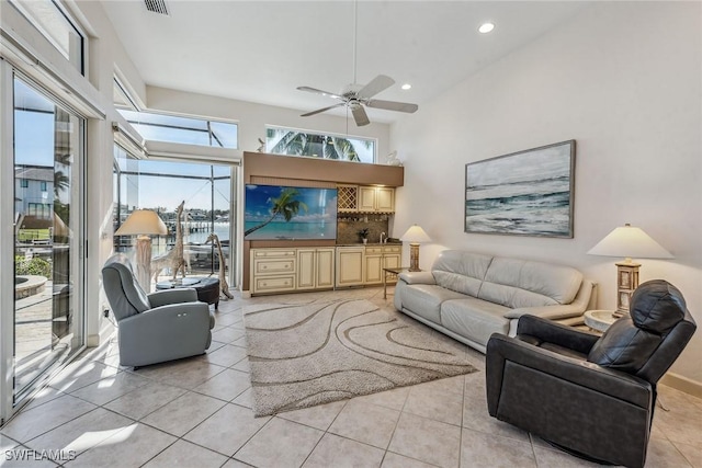 living room featuring light tile patterned floors, plenty of natural light, ceiling fan, and recessed lighting