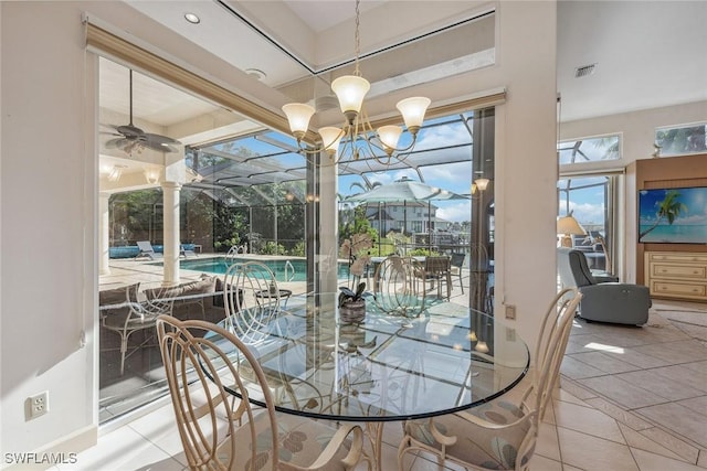 dining room with a sunroom, visible vents, ceiling fan, and light tile patterned flooring