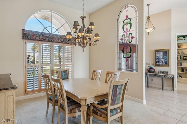 dining area featuring baseboards, high vaulted ceiling, light tile patterned flooring, and light colored carpet