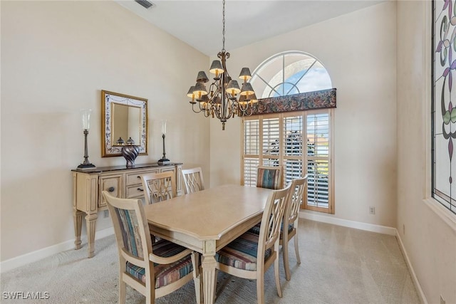 dining space with baseboards, a notable chandelier, and light colored carpet