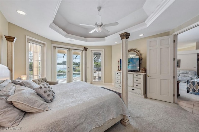 bedroom featuring light carpet, access to outside, and a raised ceiling