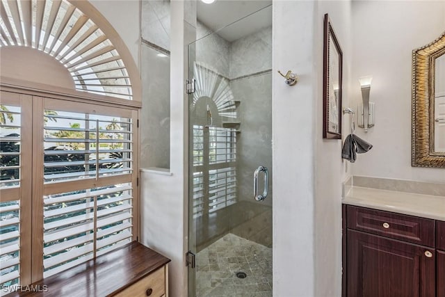 bathroom featuring a stall shower and vanity