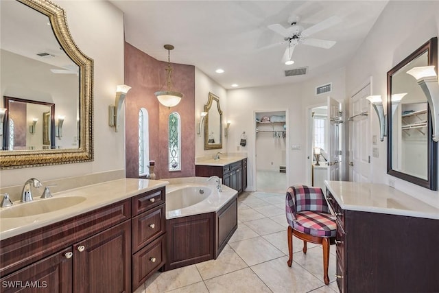 bathroom featuring two vanities, tile patterned flooring, a sink, and visible vents