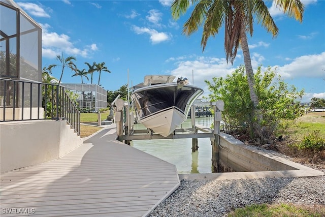 dock area featuring glass enclosure, a water view, and boat lift