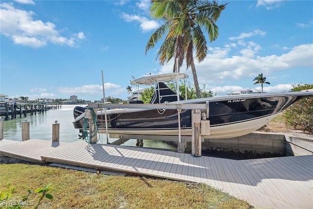 dock area with a water view and boat lift