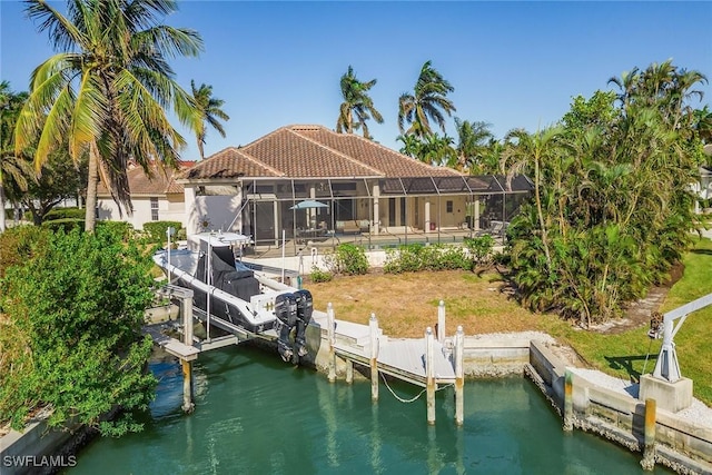 dock area featuring a water view, glass enclosure, and boat lift