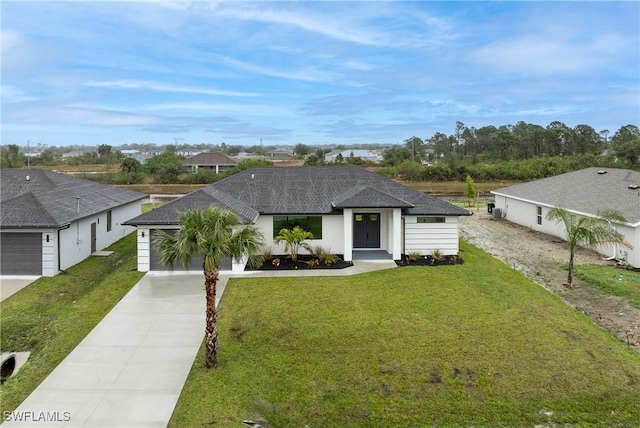 view of front of home with a garage and a front lawn