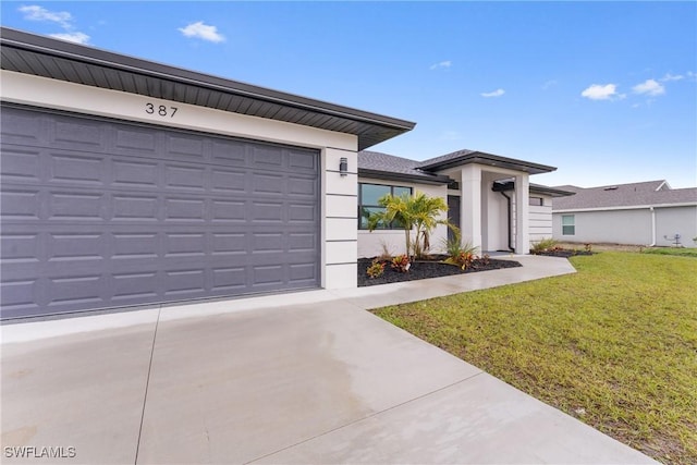 view of front of home featuring a garage and a front lawn