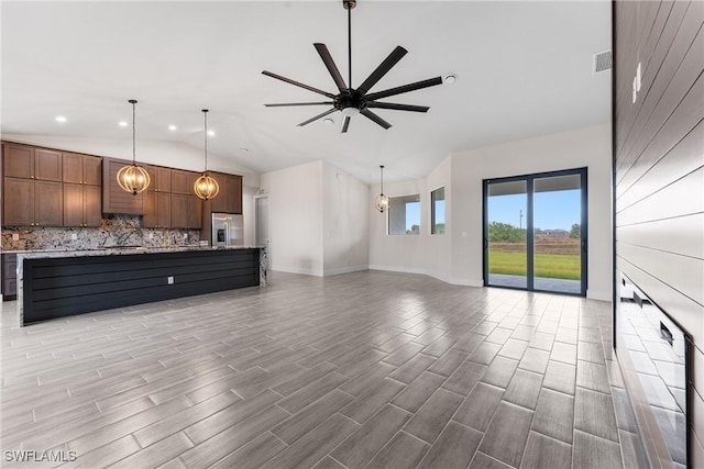 unfurnished living room with lofted ceiling and ceiling fan