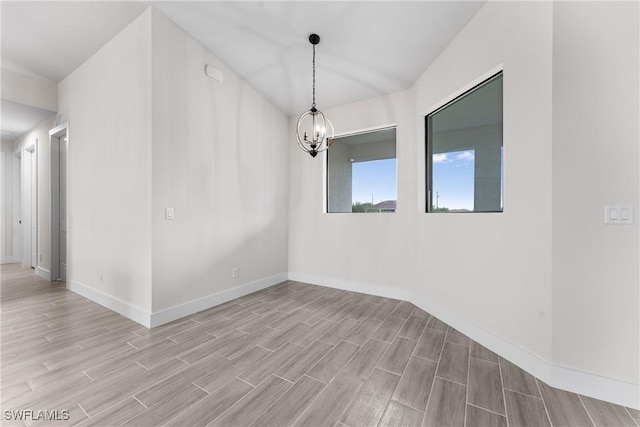 unfurnished room featuring a notable chandelier