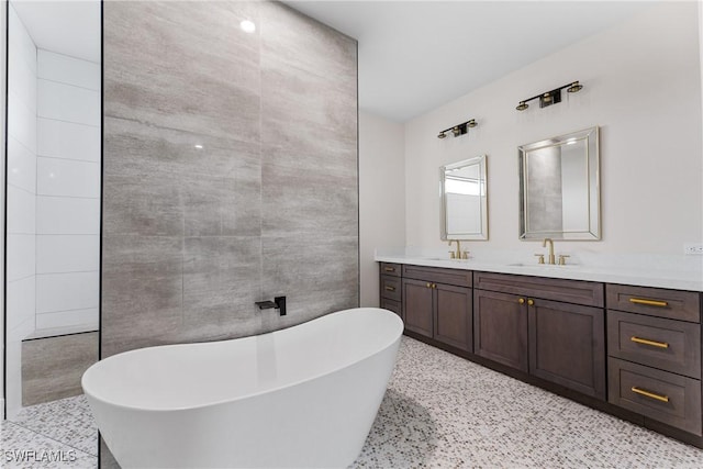 bathroom with vanity and a tub