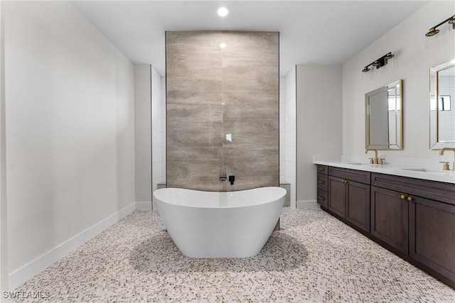 bathroom featuring vanity and a bath