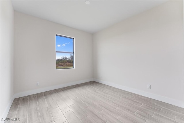 empty room with light hardwood / wood-style flooring