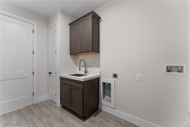 interior space with washer hookup, sink, cabinets, and hookup for an electric dryer