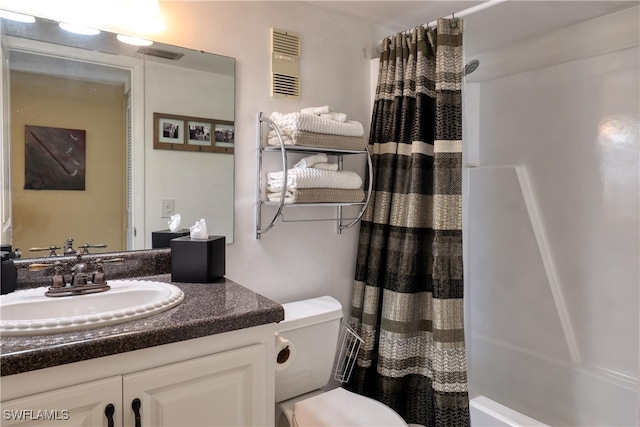 full bathroom with shower / tub combo, vanity, and toilet