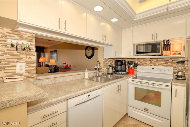 kitchen featuring sink, tasteful backsplash, crown molding, white appliances, and light tile patterned floors