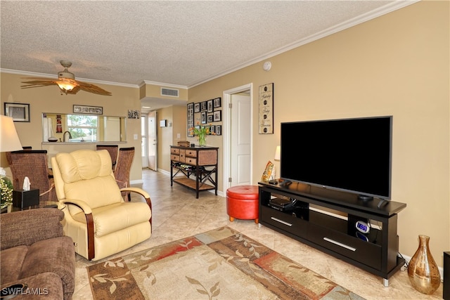 living room featuring ceiling fan, sink, crown molding, a textured ceiling, and light tile patterned floors