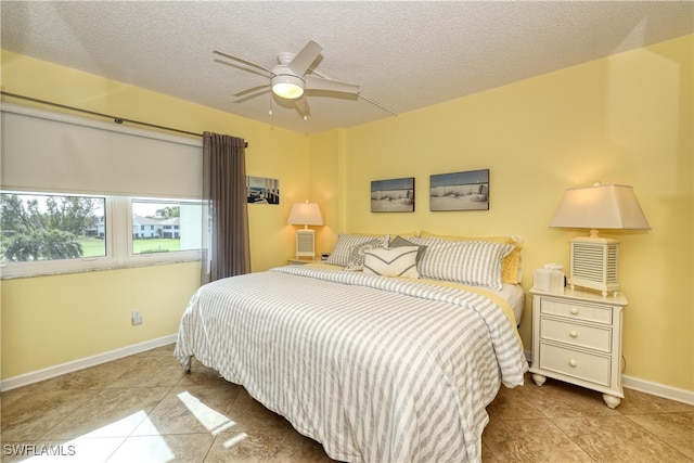 tiled bedroom featuring a textured ceiling and ceiling fan