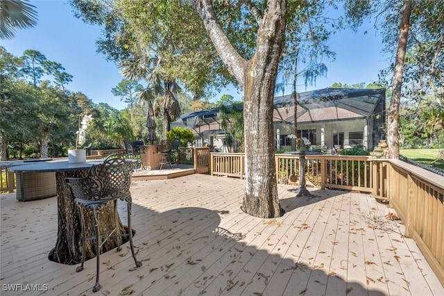 deck featuring outdoor dining space and a lanai