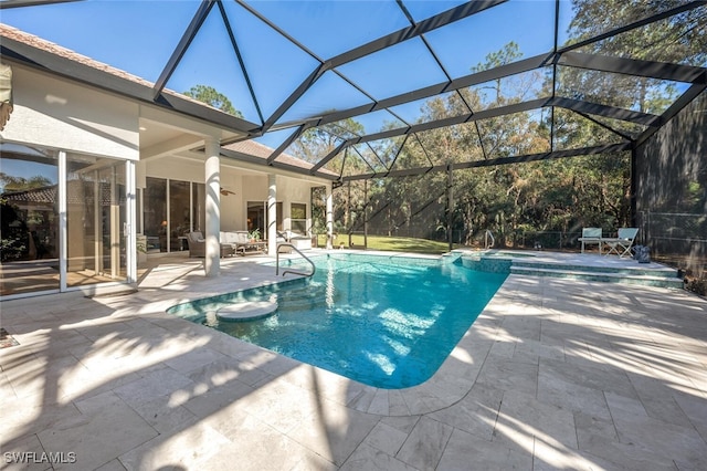 view of swimming pool featuring a patio, a lanai, and a pool with connected hot tub