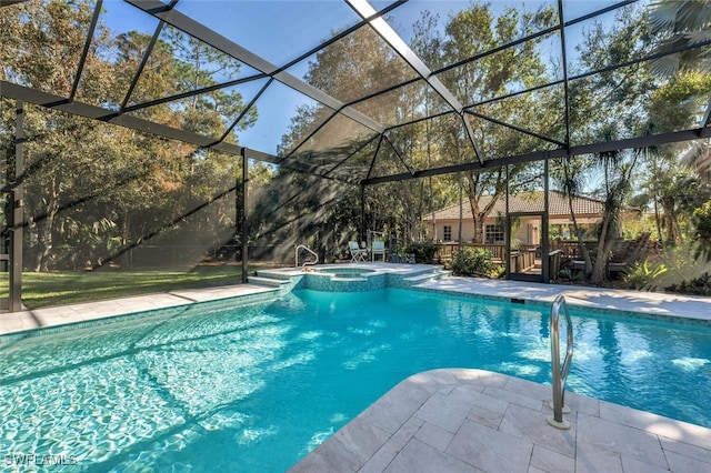 view of pool with a patio area, a lanai, and a pool with connected hot tub