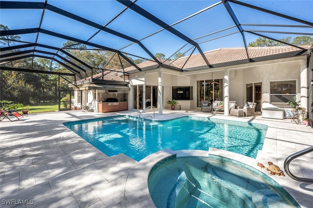 view of swimming pool with a pool with connected hot tub, an outdoor living space, exterior kitchen, and a patio