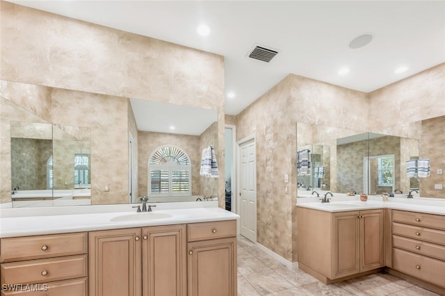 bathroom featuring recessed lighting, visible vents, tile walls, and vanity