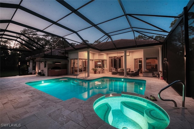 view of pool featuring a patio area, a pool with connected hot tub, and an outdoor living space