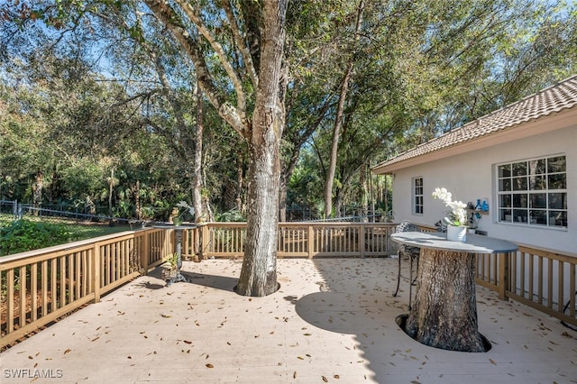 deck with outdoor dining space and fence private yard