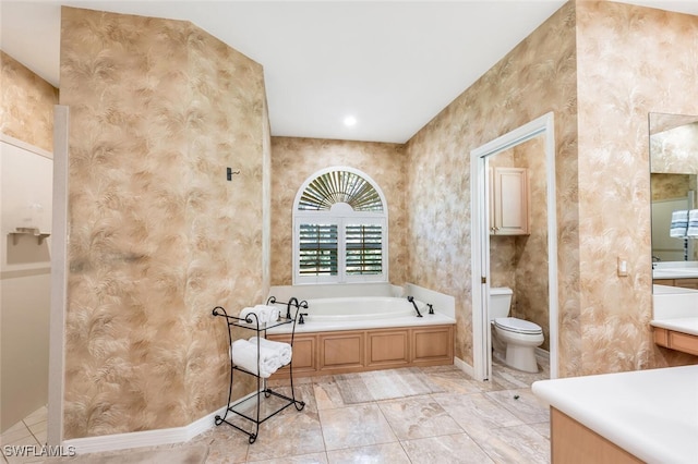 full bathroom featuring toilet, a bath, and baseboards