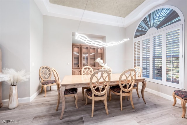 dining room with light wood finished floors and baseboards